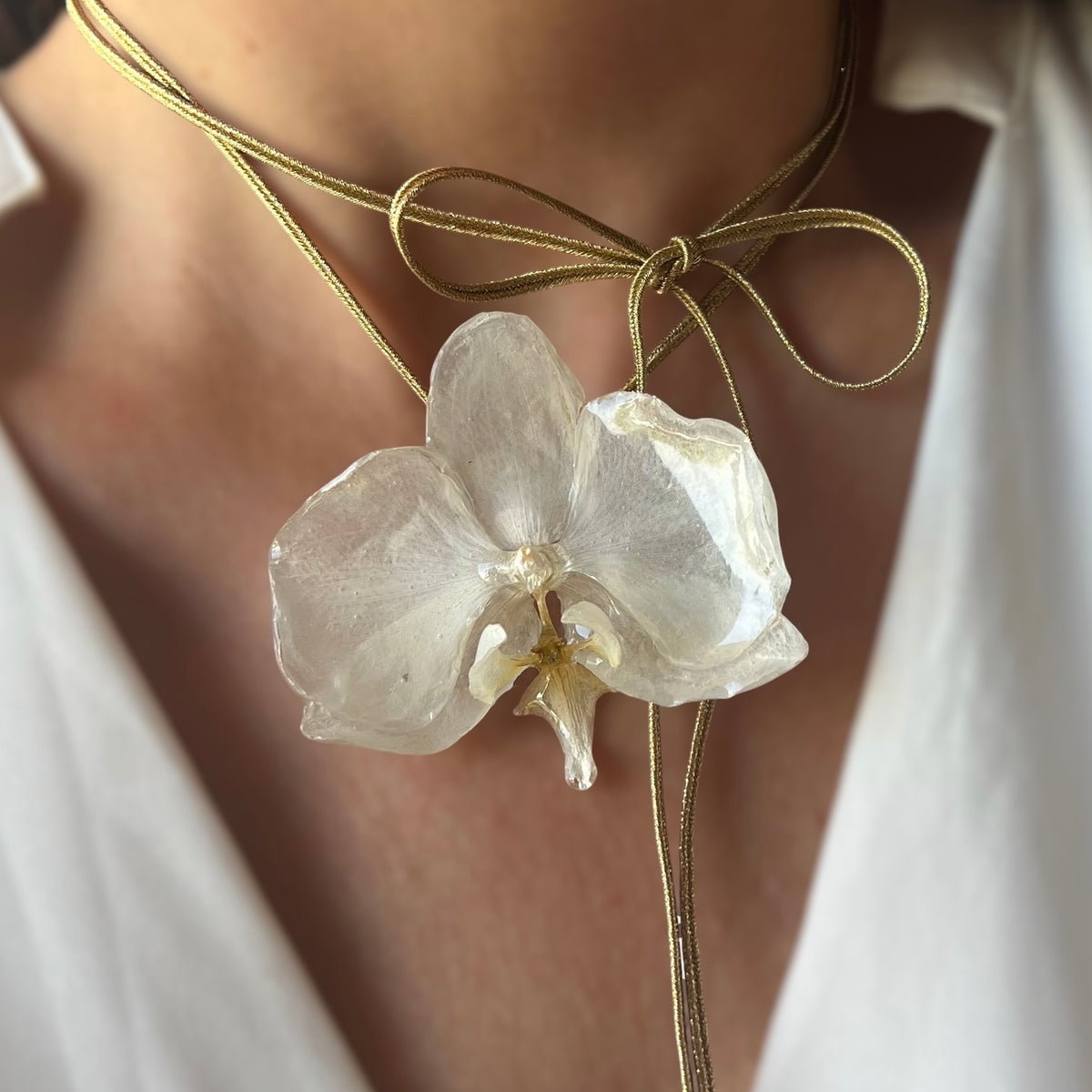 COLLARINO IN TESSUTO DORATO CON FIORE DI ORCHIDEA BIANCA VERA